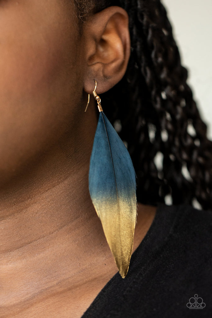 Dipped in a golden shimmer, a soft blue feather fans from the ear in a statement-making fashion. Earring attaches to a standard fishhook fitting.  Sold as one pair of earrings.
