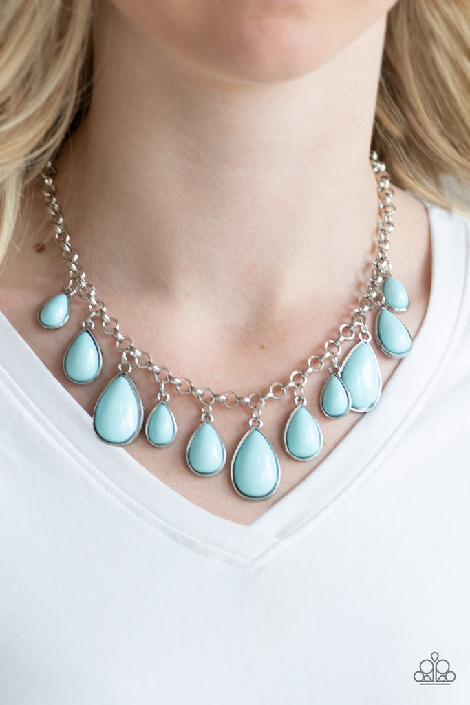 Encased in sleek silver frames, shiny blue teardrop beads drip from the bottom of a shimmery silver chain, creating a refreshing fringe below the collar. Features an adjustable clasp closure.  Sold as one individual necklace. Includes one pair of matching earrings.