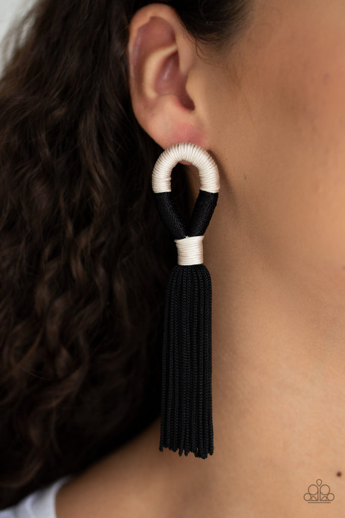 Shiny off-white and black cording knots around a round fitting as a plume of soft black cording free-falls from the bottom, creating a trendy tassel. Earring attaches to a standard post fitting. Sold as one pair of post earrings.  Sold as one pair of post earrings.