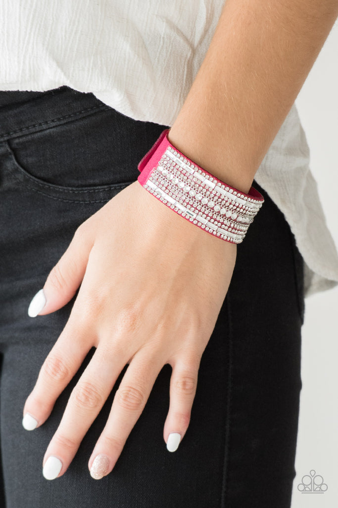 Featuring classic round and edgy emerald style cuts, glittery white rhinestones and glistening silver chains are encrusted along bands of pink suede for a sassy look. Features an adjustable snap closure.  Sold as one individual bracelet.