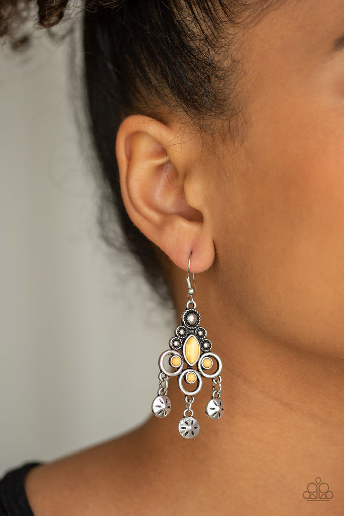 Floral stamped discs swing from the bottom of an ornate silver frame radiating with sunny yellow stones and studded silver accents for a seasonal look. Earring attaches to a standard fishhook fitting.  Sold as one pair of earrings.