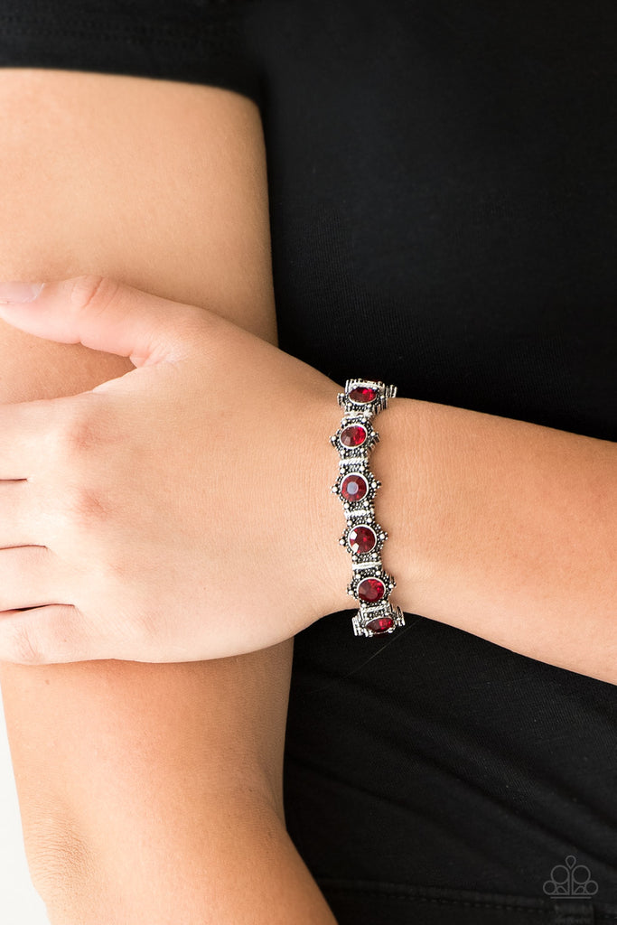 Featuring glittery red rhinestone centers, ornate silver frames are threaded along stretchy bands, linking across the wrist for a refined look.  Sold as one individual bracelet.