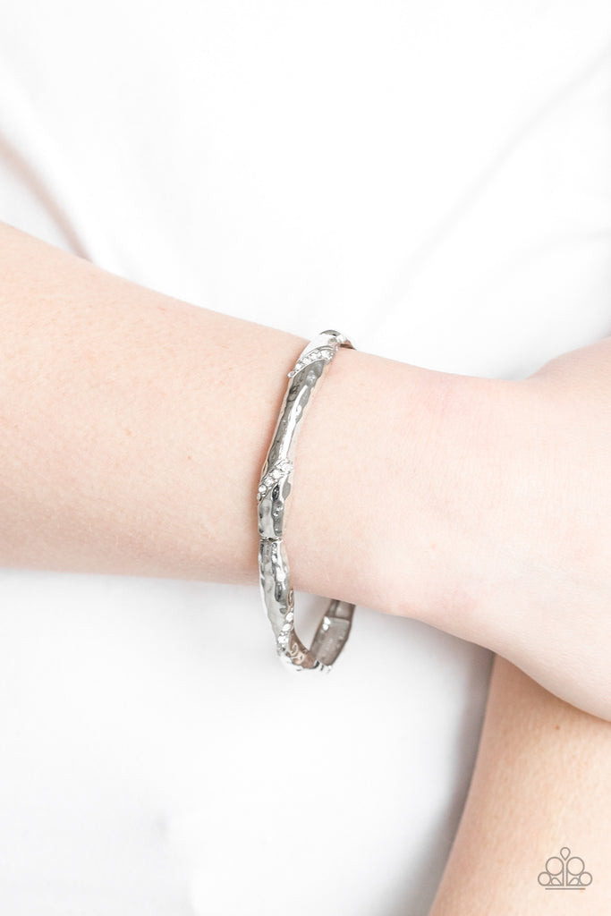 Encrusted in ribbons of glassy white rhinestones, hammered silver frames are threaded along a stretchy band around the wrist for a refined look.  Sold as one individual bracelet.