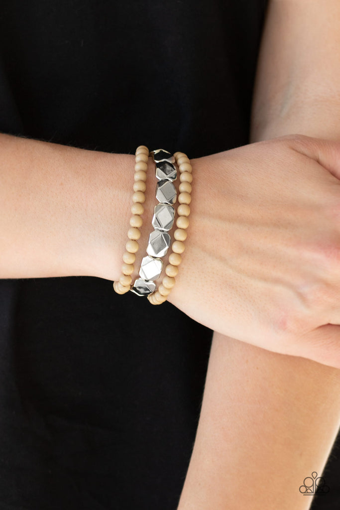 A collection of polished brown and faceted silver beads are threaded along stretchy bands, creating colorful layers around the wrist.  Sold as one of three bracelets.