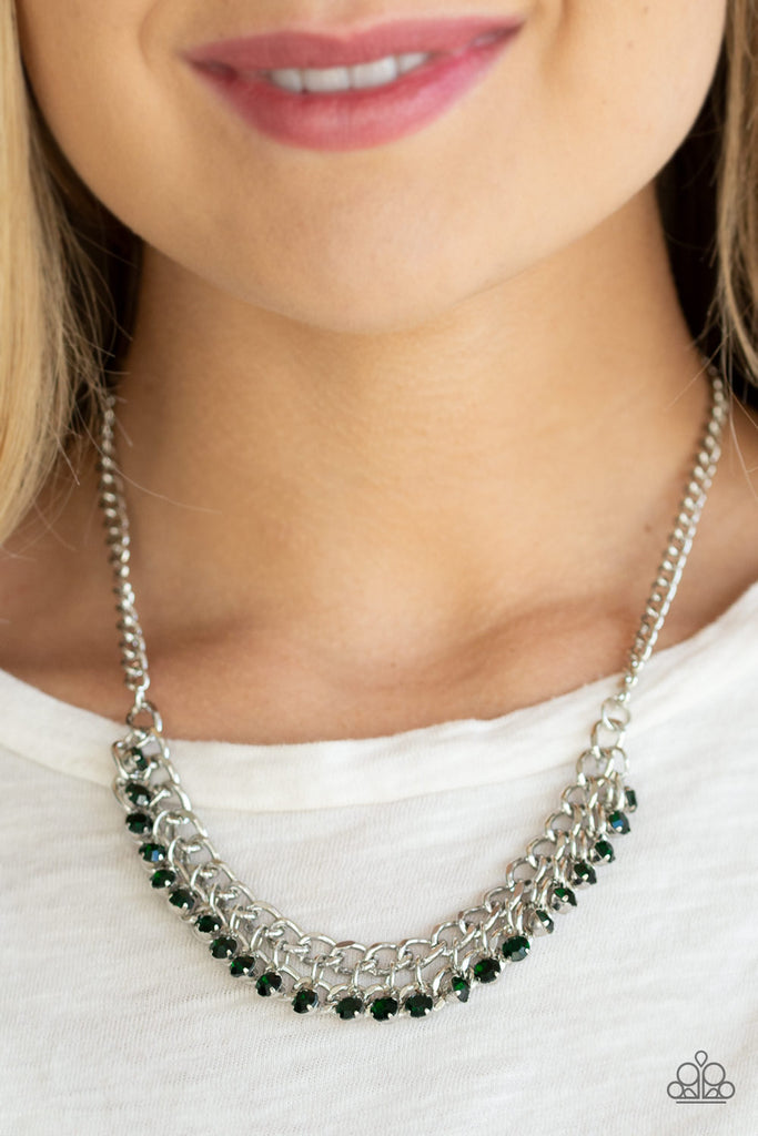 A fringe of glittery green rhinestones swings from the bottom of a bold silver chain below the collar for a fierce look. Features an adjustable clasp closure.  Sold as one individual necklace. Includes one pair of matching earrings.
