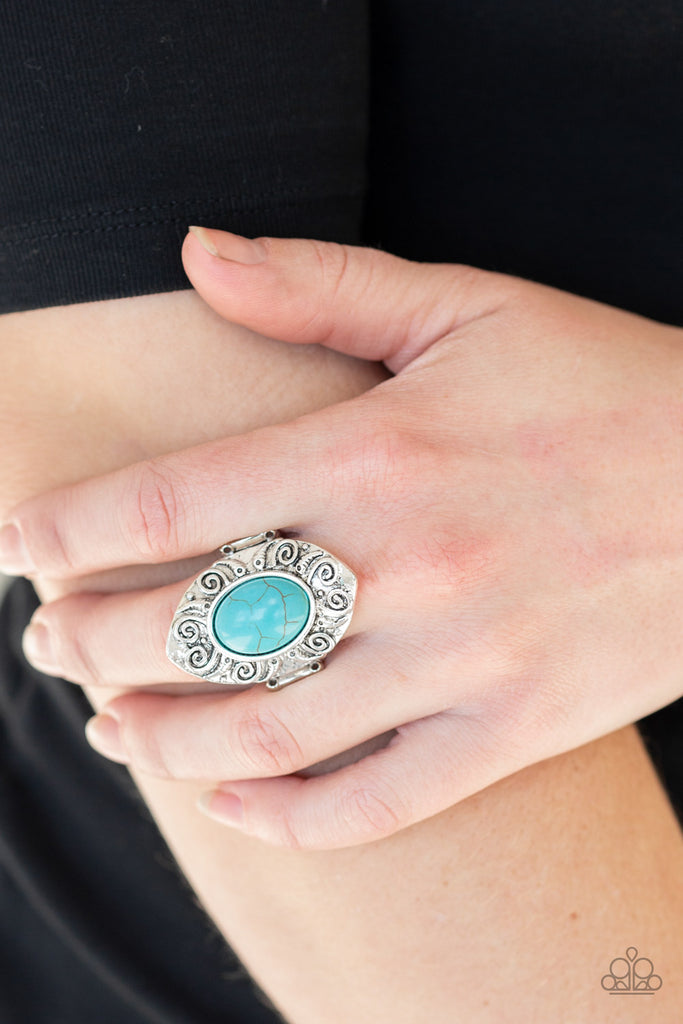 A refreshing turquoise stone is pressed into a shimmery silver frame embossed in swirling details for an artisan inspired look. Features a stretchy band for a flexible fit.  Sold as one individual ring.  