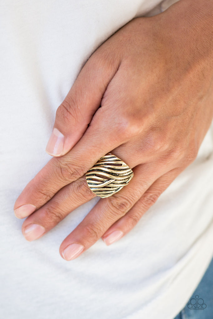 Brushed in an antiqued shimmer, glistening brass bars delicately crisscross across the finger, coalescing into an edgy frame. Features a stretchy band for a flexible fit.  Sold as one individual ring.