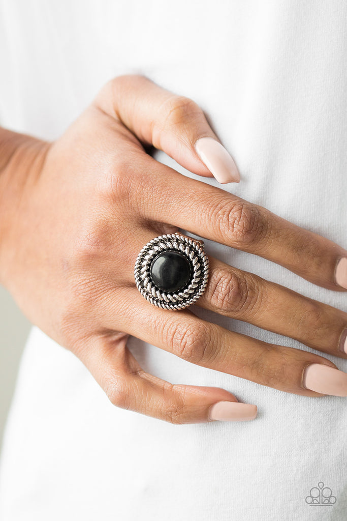 A smooth black stone is pressed into an antiqued silver frame radiating with twisted rope-like textures for an artisan inspired look. Features a stretchy band for a flexible fit.  Sold as one individual ring.  