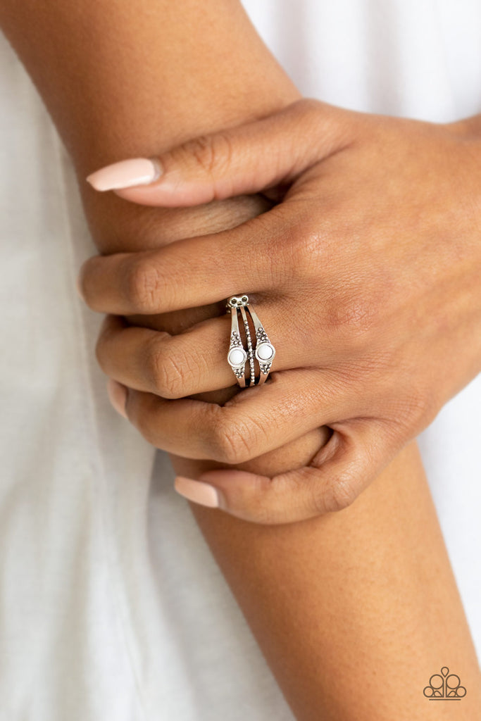 Dotted in shimmery silver studs, antiqued silver bands stack across the finger. Two shiny white beads are pressed into the upper and lower bands for a colorful finish. Features a dainty stretchy band for a flexible fit.  Sold as one individual ring.