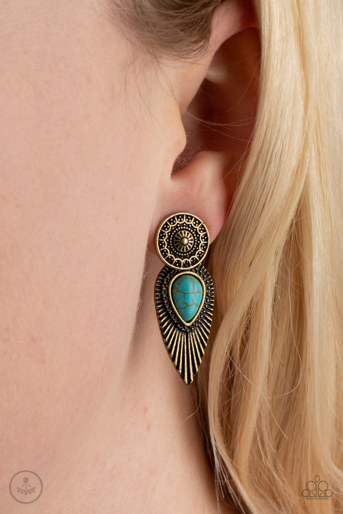 An ornate brass disc attaches to a double-sided post, designed to fasten behind the ear. Dotted with a turquoise stone center, the feathery double-sided post peeks out beneath the ear for a bold artisan look. Earring attaches to a standard post fitting.  Sold as one pair of double-sided post earrings.