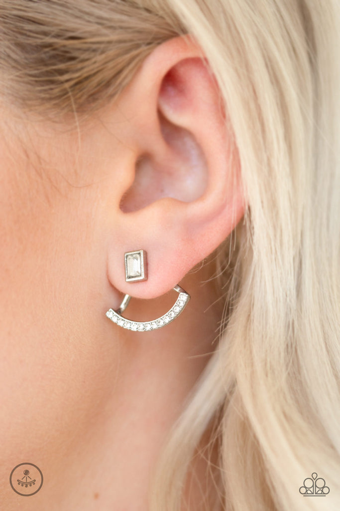 A solitaire emerald-cut rhinestone attaches to a double-sided post, designed to fasten behind the ear. Radiating with a bowing row of white rhinestones, the double sided-post peeks out beneath the ear for an edgy look. Earring attaches to a standard post fitting.  Sold as one pair of double-sided post earrings.  