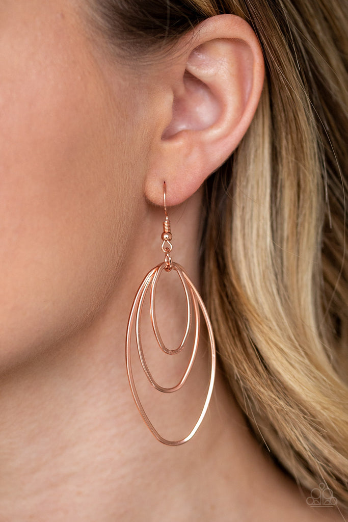 Gradually increasing in size, a trio of shiny copper oval frames trickle from the ear, coalescing into an airy lure. Earring attaches to a standard fishhook fitting.  Sold as one pair of earrings.