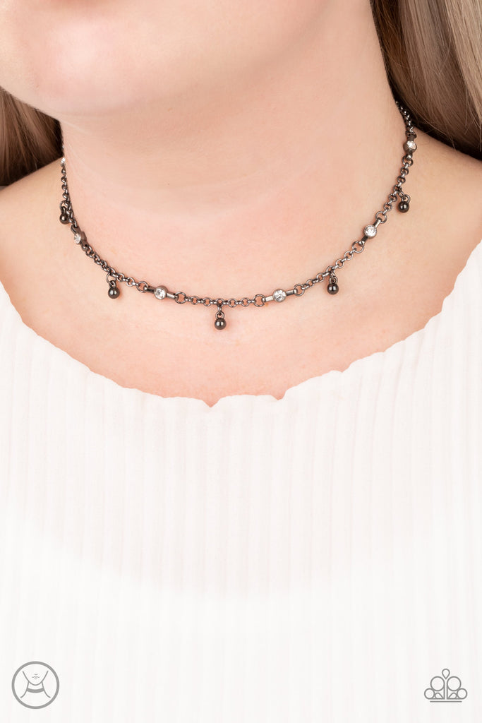 Featuring sleek fittings, dainty white rhinestones link with sections of glistening gunmetal chain around the neck. Shiny gunmetal beads dangle from the chain for a flirtatious finish. Features an adjustable clasp closure.  Sold as one individual choker necklace. Includes one pair of matching earrings.  