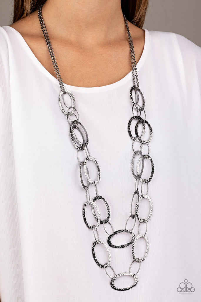 Delicately hammered in shimmery textures, two rows of glistening gunmetal hoops layer down the chest for a sleek look. Features an adjustable clasp closure.  Sold as one individual necklace. Includes one pair of matching earrings.