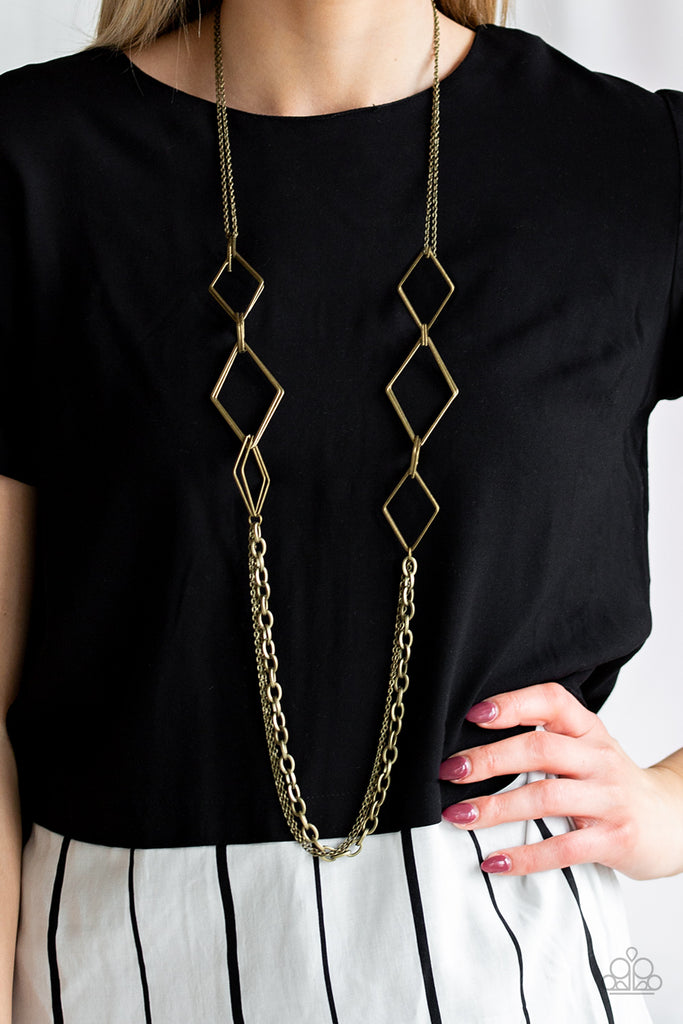 A collection of interlocking diamond-shaped frames give way to rows of mismatched brass chains, creating edgy layers across the chest. Features an adjustable clasp closure.  Sold as one individual necklace. Includes one pair of matching earrings.  