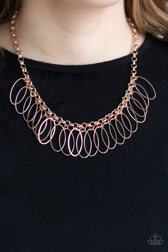 Oval shiny copper, rose gold, and silver frames dangle from a bold rose gold chain, creating a dizzying fringe below the collar. Features an adjustable clasp closure.  Sold as one individual necklace. Includes one pair of matching earrings.  