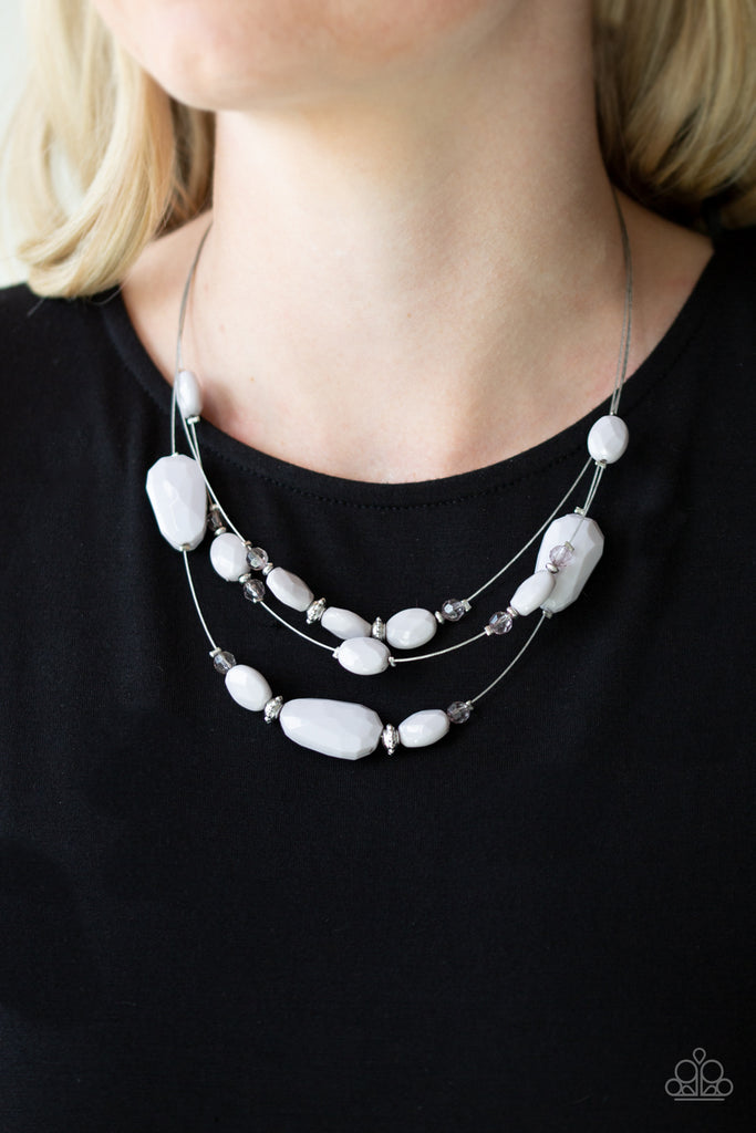 Infused with dainty metallic accents, a collection of faceted gray and sparkling crystal-like beads are threaded along invisible wires below the collar for a whimsically layered look. Features an adjustable clasp closure.  Sold as one individual necklace. Includes one pair of matching earrings.