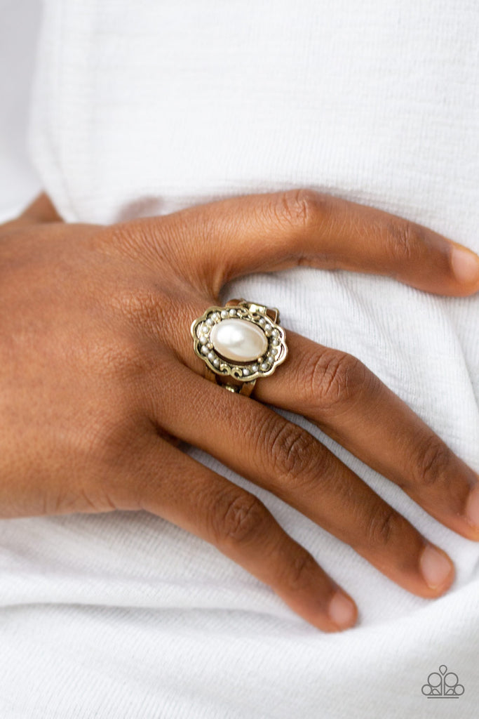 A pearly white bead is pressed into the center of an antiqued floral frame dotted with dainty white pearls for a whimsical fashion. Feature a stretchy band for a flexible fit.  Sold as one individual ring.