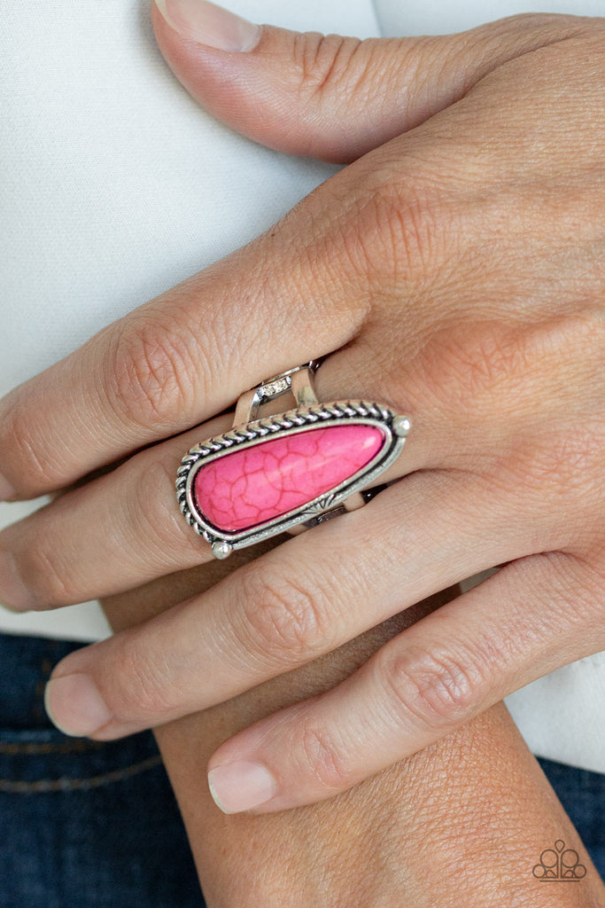 Chiseled into an oblong teardrop shape, a vivacious pink stone is pressed into an asymmetrically patterned silver frame for an artisan inspired look. Features a stretchy band for a flexible fit.  Sold as one individual ring.  
