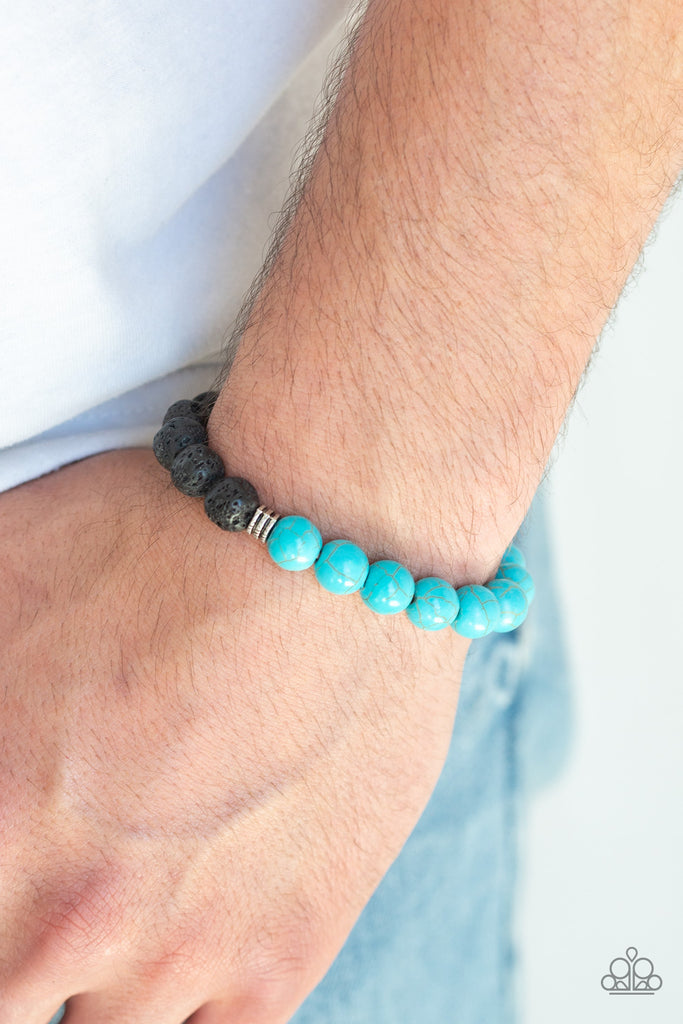 A collection of dainty silver accents, black lava rock beads, and refreshing turquoise stones are threaded along a stretchy band around the wrist for a seasonal style.  Sold as one individual bracelet.  