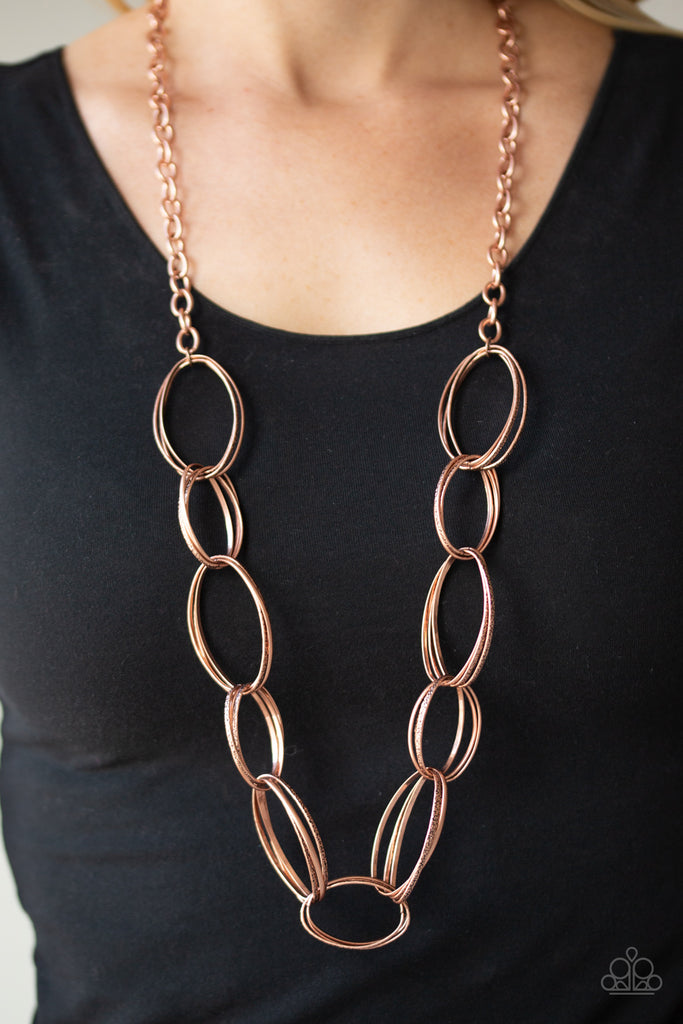 A collision of smooth and hammered copper oval links connect across the chest for a dramatic industrial look. Features an adjustable clasp closure.  Sold as one individual necklace. Includes one pair of matching earrings.