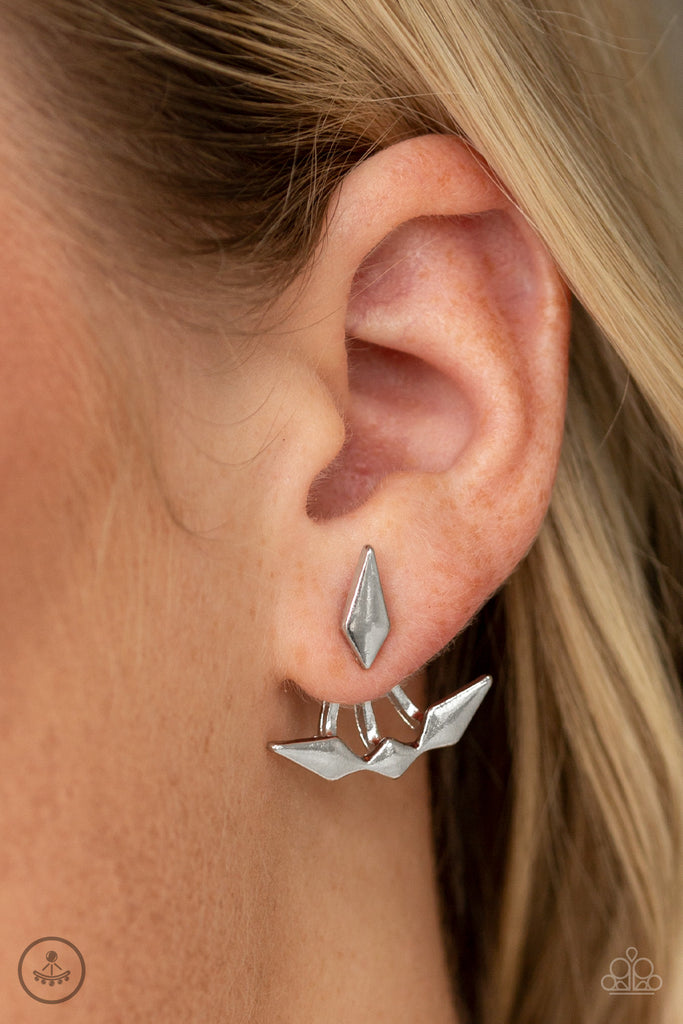 A solitaire silver kite-shaped frame attaches to a double-sided post, designed to fasten behind the ear. Infused with matching kite-shaped frames, the double sided-post peeks out beneath the ear for an edgy look. Earring attaches to a standard post fitting.  Sold as one pair of double-sided post earrings.