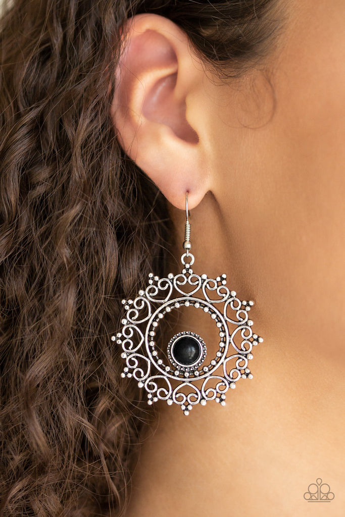 Featuring studded details, frilly heart-shaped filigree spins around a smooth black stone bead, creating a whimsical wreath. Earring attaches to a standard fishhook fitting.  Sold as one pair of earrings.