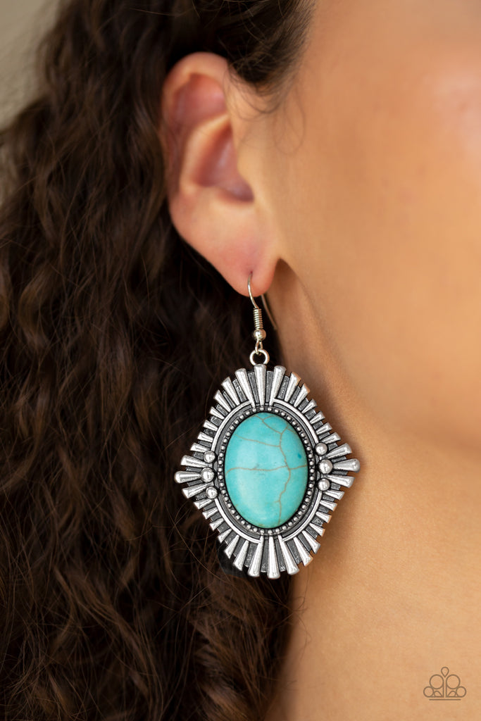 Dotted with studded accents, blunted silver frames flare from a turquoise stone center for a seasonal look. Earring attaches to a standard fishhook fitting.  Sold as one pair of earrings.  