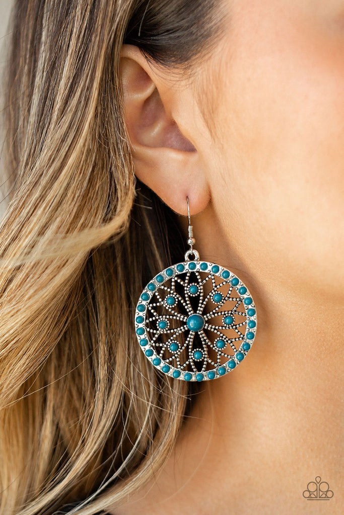 Dainty blue beads are sprinkled along a shimmery silver frame swirling with floral filled filigree, creating a whimsical mandala-like frame. Earring attaches to a standard fishhook fitting.  Sold as one pair of earrings.