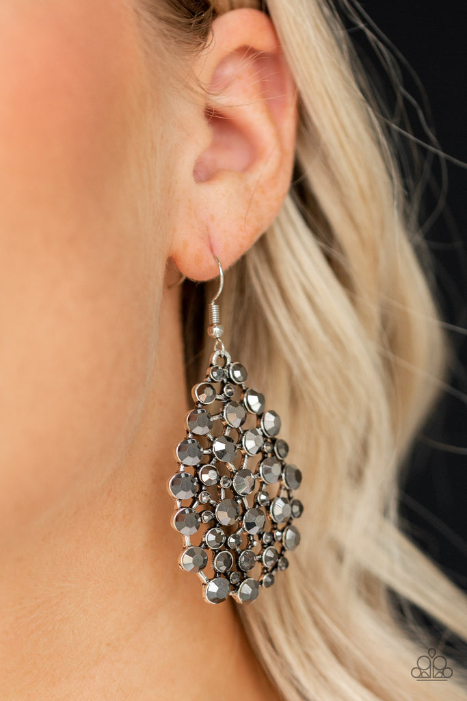 An explosion of glittery hematite rhinestones coalesces into a blinding teardrop frame for a statement-making look. Earring attaches to a standard fishhook fitting.  Sold as one pair of earrings.