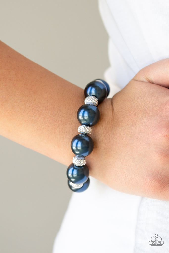 A refined collection of oversized blue pearls and glittery metallic encrusted silver beads are threaded along a stretchy band around the wrist for a glamorous touch.  Sold as one individual bracelet.