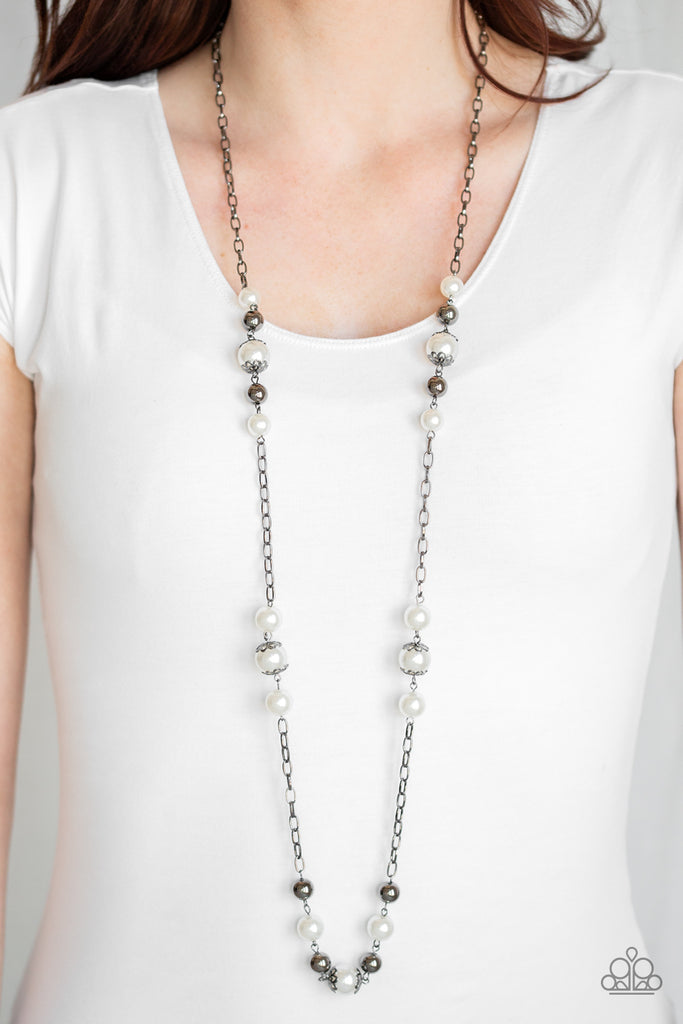 Capped in ornate gunmetal frames, a collection of bubbly white pearls and glistening gunmetal beads trickle along sections of a shiny gunmetal chain across the chest for a timeless sophistication. Features an adjustable clasp closure.  Sold as one individual necklace. Includes one pair of matching earrings.