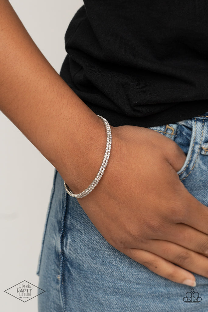 Dotted in dainty white rhinestones, a flexible wire coils around the wrist for a refined flair.  Sold as one individual bracelet.
