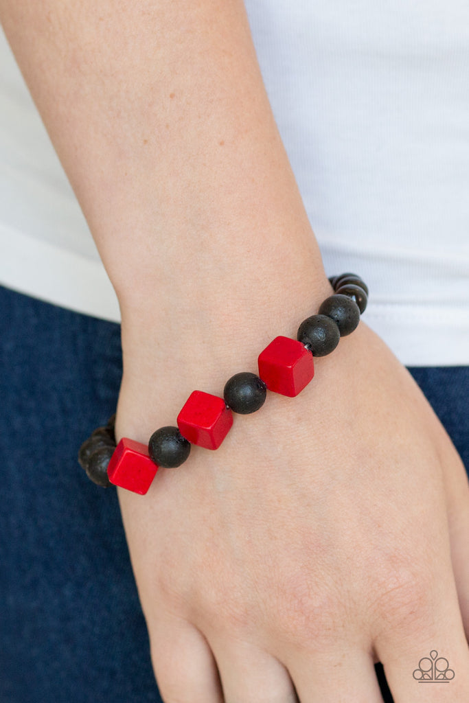 An earthy collection of shiny black beads, black lava rock beads, and red wooden cubes are threaded along a stretchy band around the wrist for a seasonal flair.  Sold as one individual bracelet.  