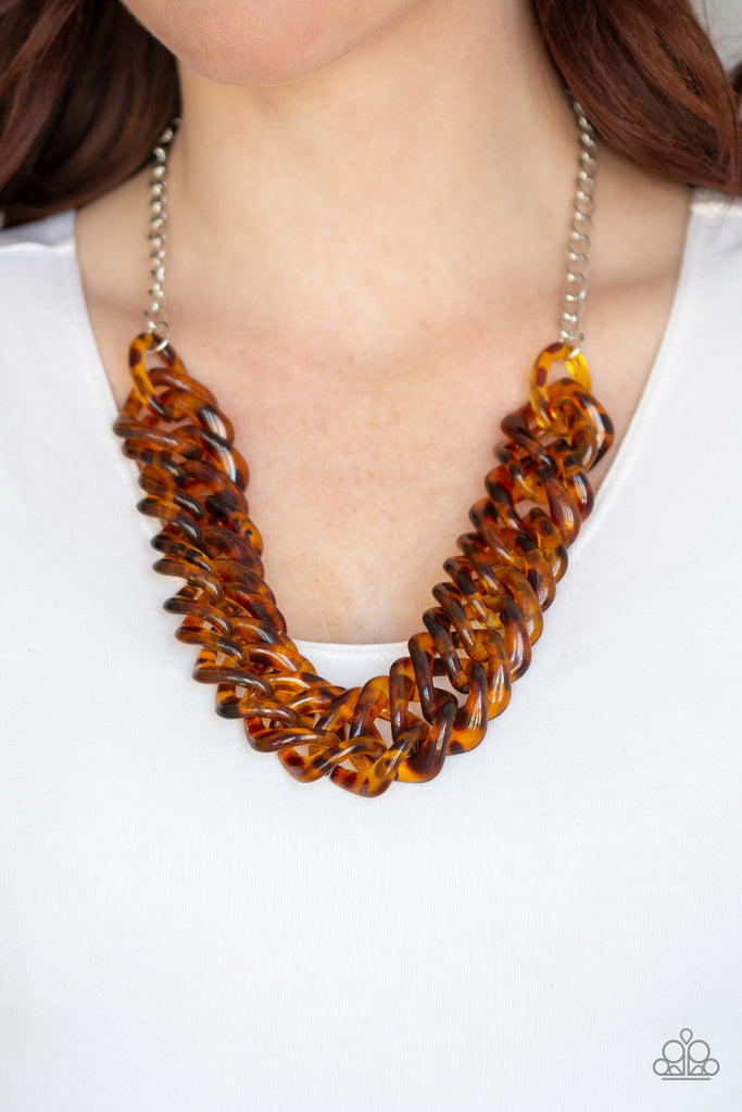 Featuring a tortoise shell finish, square brown acrylic links subtlety twist as they link below the collar for a colorful statement-making look. Features an adjustable clasp closure.  Sold as one individual necklace. Includes one pair of matching earrings.  