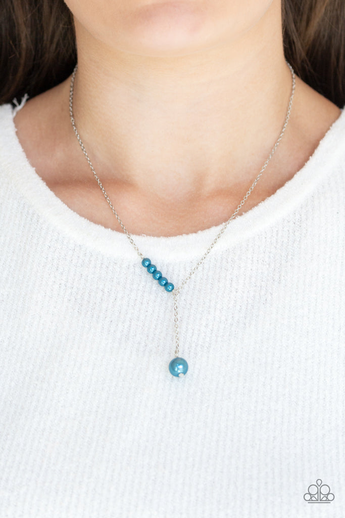 A solitaire blue pearl swings from the bottom of a glistening silver chain, creating a timeless extended pendant below the collar. A section of dainty blue pearls dot one side of the chain for a refined asymmetrical finish. Features an adjustable clasp closure.  Sold as one individual necklace. Includes one pair of matching earrings.