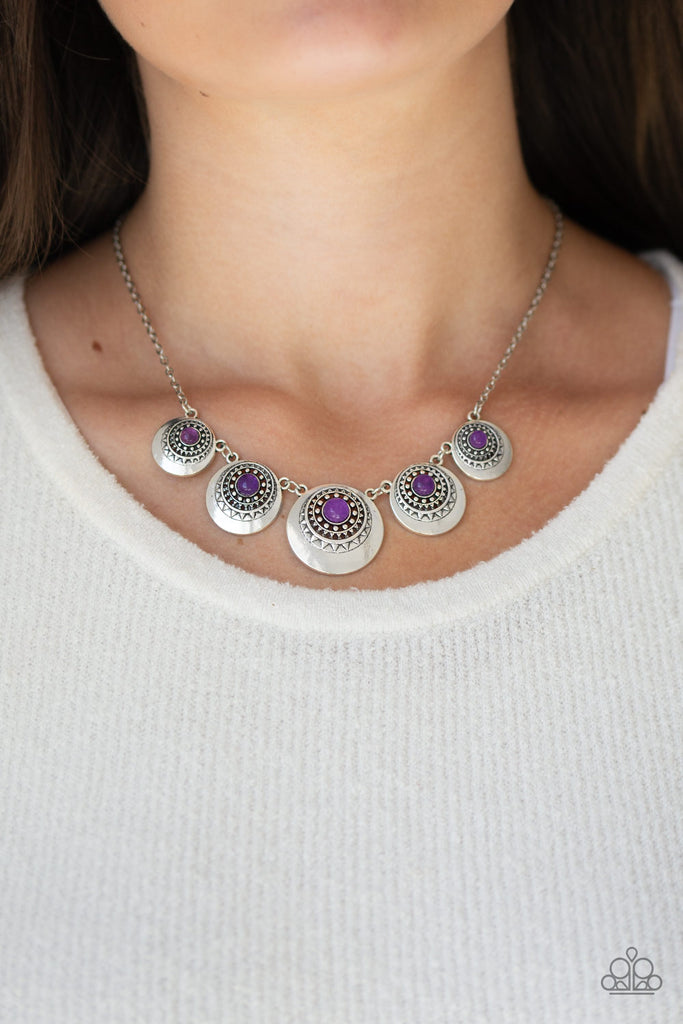 Dotted with glassy purple stone centers, silver sunburst studded frames link below the collar, creating a colorful fringe. Features an adjustable clasp closure.  Sold as one individual necklace. Includes one pair of matching earrings.