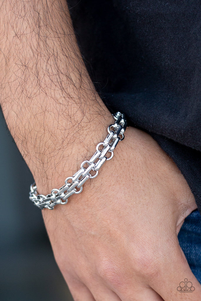 Doubled silver links connect around the wrist for an abstract urban look. Features an adjustable clasp closure.  Sold as one individual bracelet.  