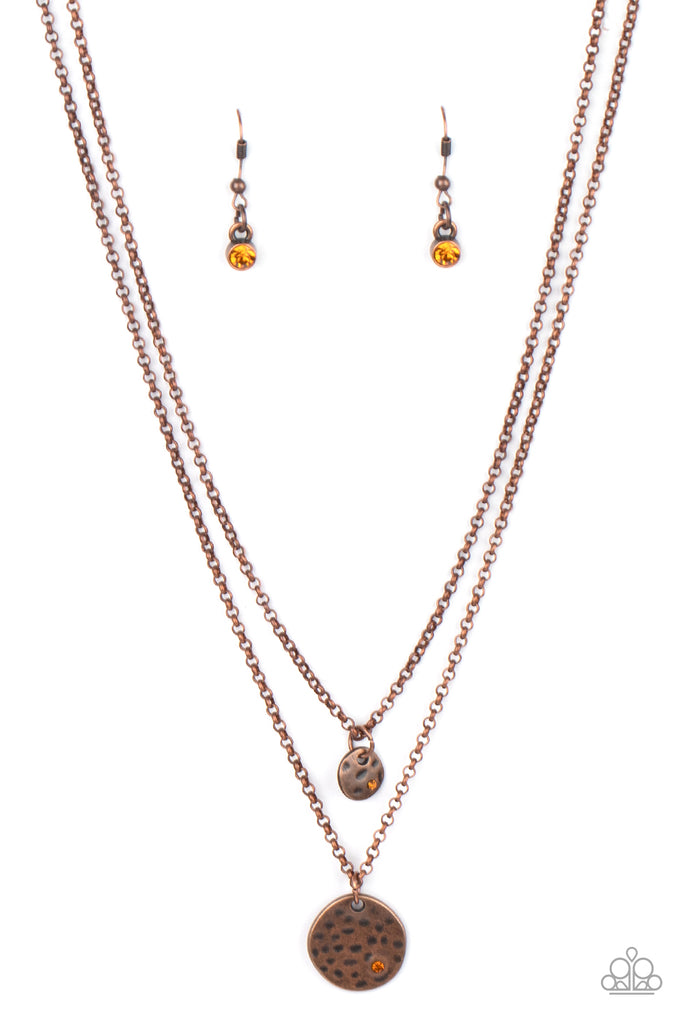 Dotted with dainty topaz rhinestones, a pair of hammered copper discs delicately layer below the collar for a dainty look. Features an adjustable clasp closure.  Sold as one individual necklace. Includes one pair of matching earrings.