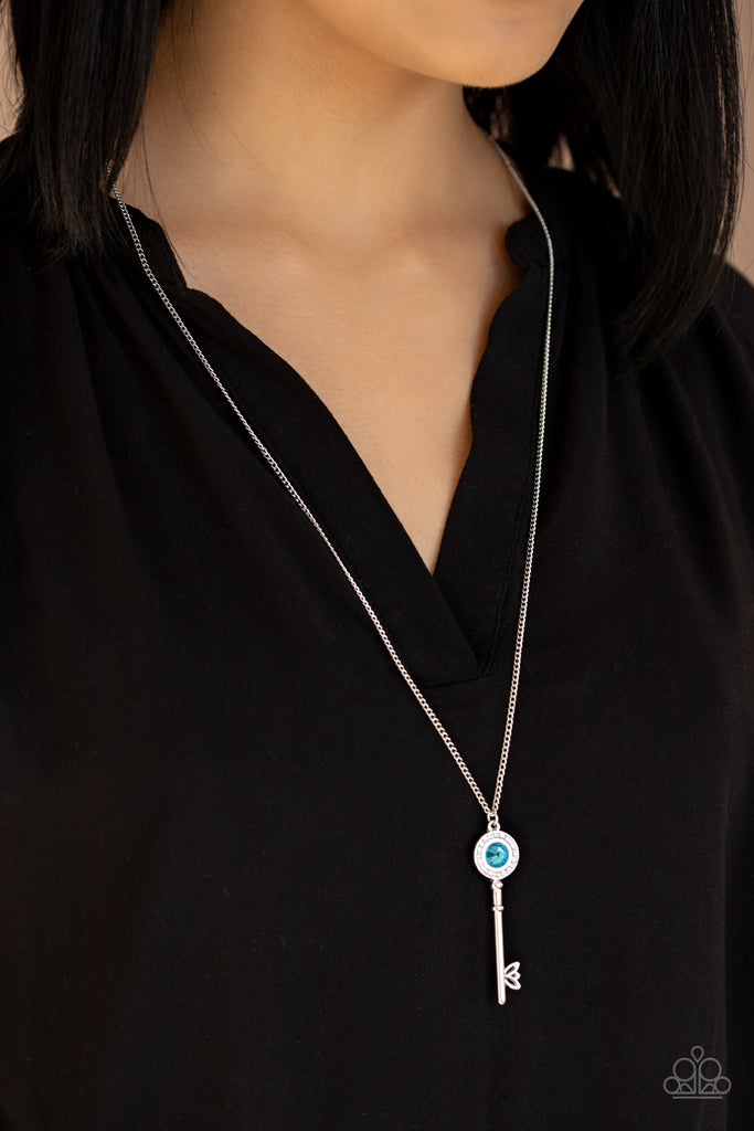 Dotted with an oversized blue gem center, a ring of white rhinestones encrust the top of an ornate silver key, creating a dazzling pendant at the bottom of a lengthened silver chain. Features an adjustable clasp closure.  Sold as one individual necklace. Includes one pair of matching earrings.