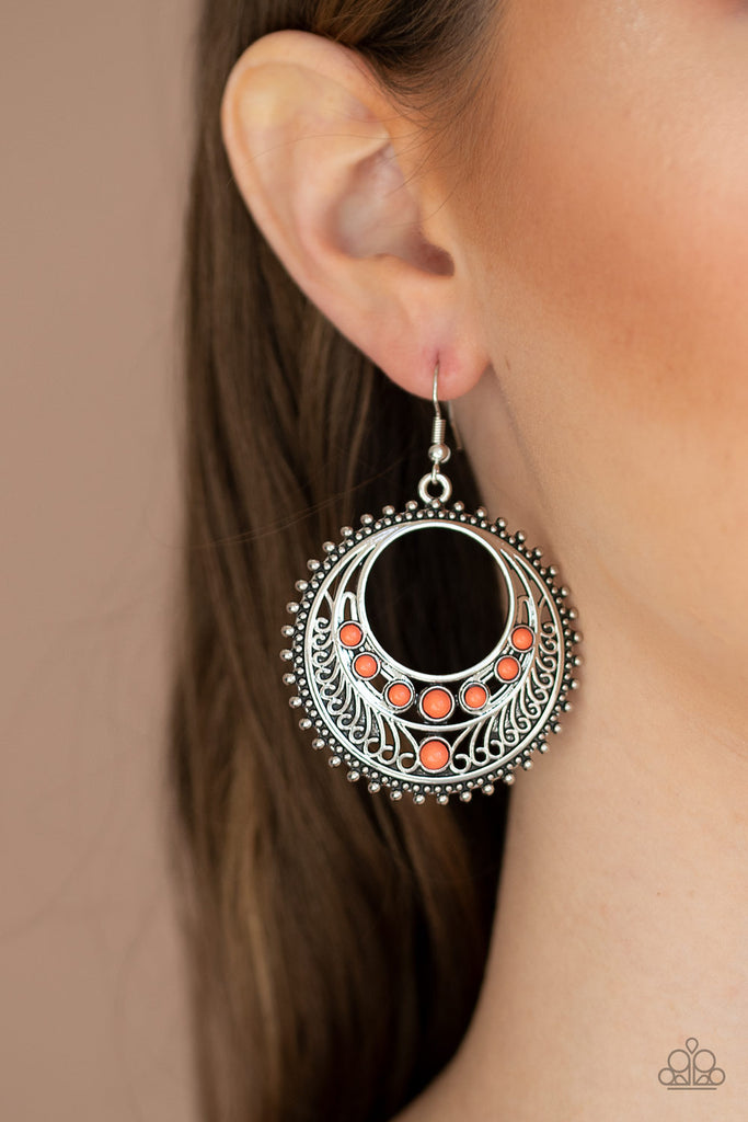 Dainty Living Coral beads dot an airy silver hoop swirling with shiny filigree and studded textures, creating a whimsical frame. Earring attaches to a standard fishhook fitting.  Sold as one pair of earrings.