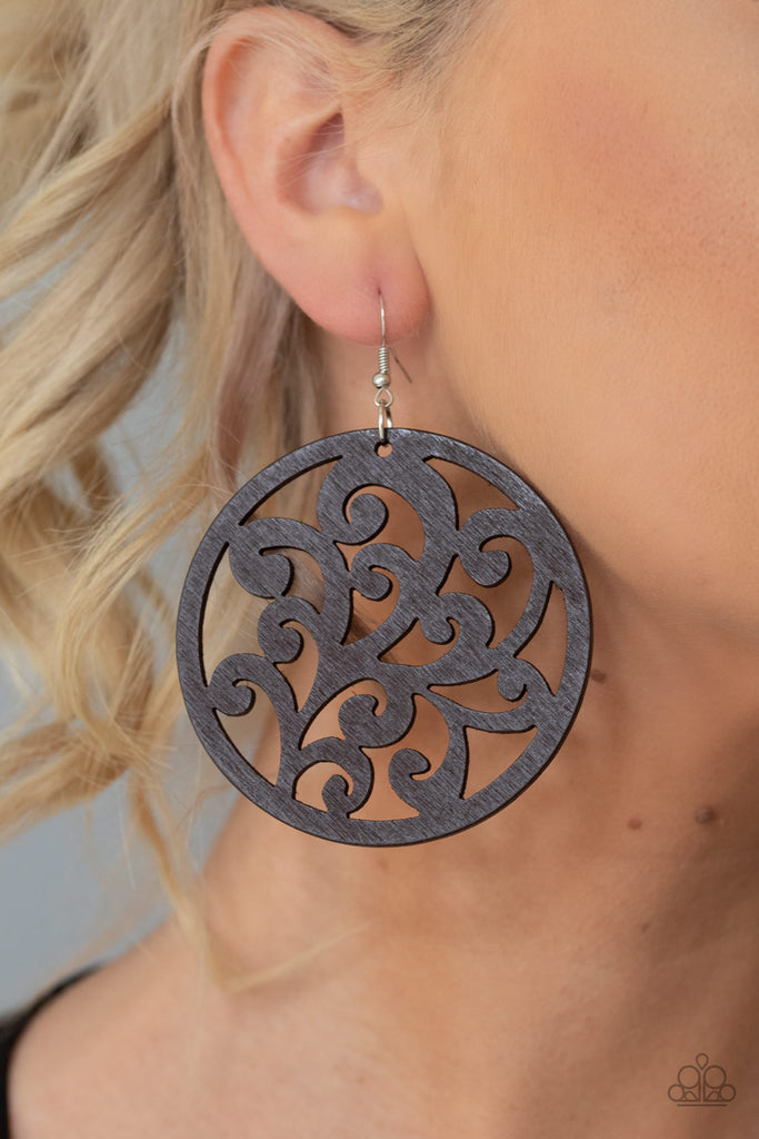 Stenciled in vine-like filigree, a wooden frame swings from the ear for an earthy look. Earring attaches to a standard fishhook fitting.  Sold as one pair of earrings.