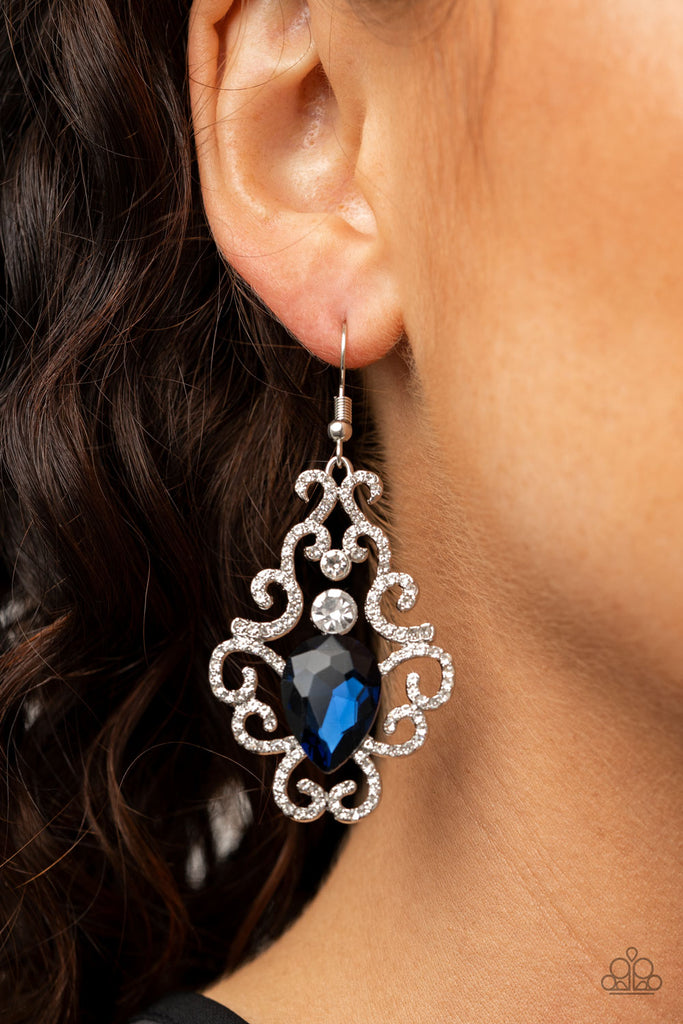 White rhinestone encrusted silver bars delicately vine around a white rhinestone and blue teardrop rhinestone center, creating an unapologetic glow. Earring attaches to a standard fishhook fitting.  Sold as one pair of earrings.