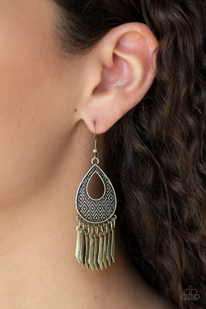 Embossed in a bold geometric pattern, a glistening brass teardrop frame gives way to a fringe of flared brass rods for a seasonal flair. Earring attaches to a standard fishhook fitting. Sold as one pair of earrings.