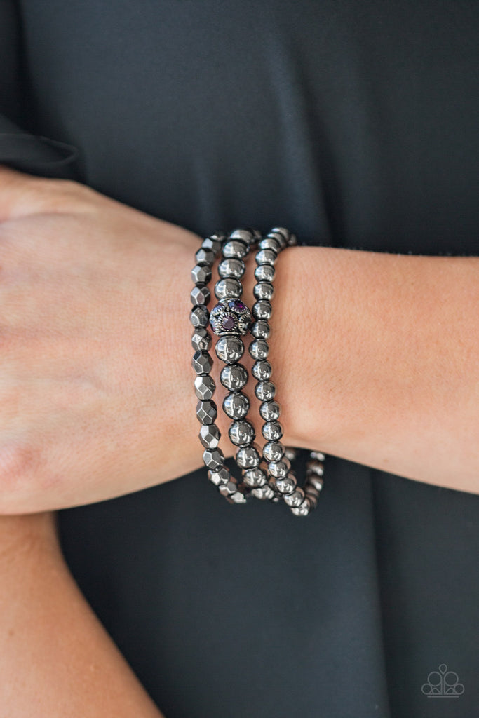 Mismatched gunmetal beads and purple rhinestone encrusted beads are threaded along stretchy bands for an edgy and refined look.  Sold as one set of three bracelets.