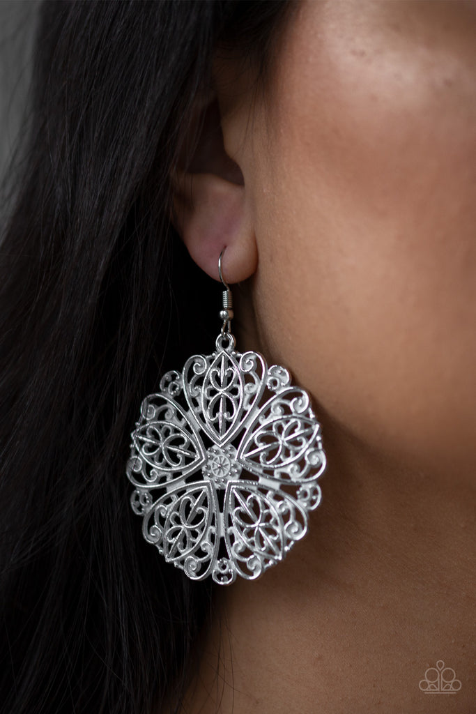 Brushed in a refreshing white finish, ornate silver filigree spins into a whimsical floral pattern for a seasonal flair. Earring attaches to a standard fishhook fitting.  Sold as one pair of earrings.