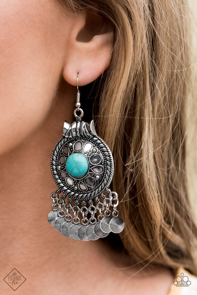 An earthy blue stone is pressed into the center of a floral stamped silver frame for a seasonal look. Textured silver discs dangle from the bottom of the frame, creating a whimsical fringe. Earring attaches to a standard fishhook fitting.  Sold as one pair of earrings.