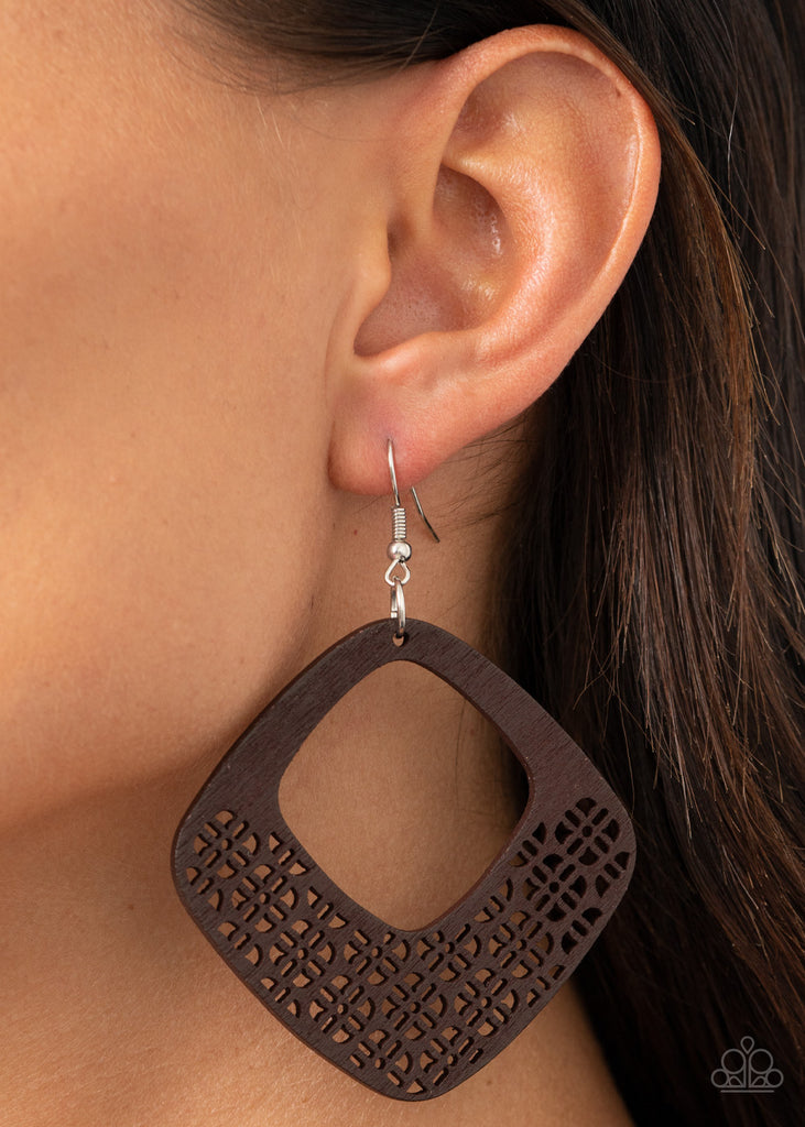 Painted in a neutral brown finish, the bottom of a wooden diamond-shaped frame has been cut into an airy floral stenciled pattern for a whimsical finish. Earring attaches to a standard fishhook fitting.  Sold as one pair of earrings.