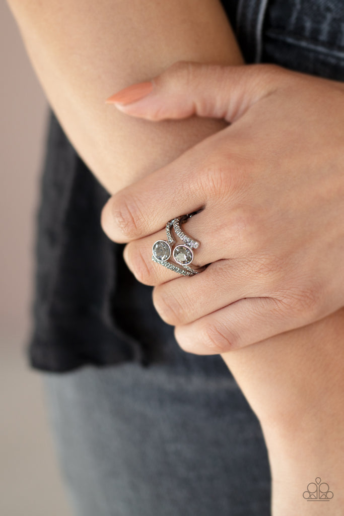 Two oversized smoky rhinestones sit atop two zigzagging silver bands encrusted in dainty hematite rhinestones. Features a dainty stretchy band for a flexible fit.  Sold as one individual ring.