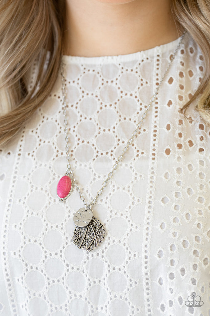 An oval pink stone, hammered silver disc, and lifelike silver leaf charm swing from the bottom of a lengthened silver chain, creating a whimsical pendant. Features an adjustable clasp closure.  Sold as one individual necklace. Includes one pair of matching earrings.